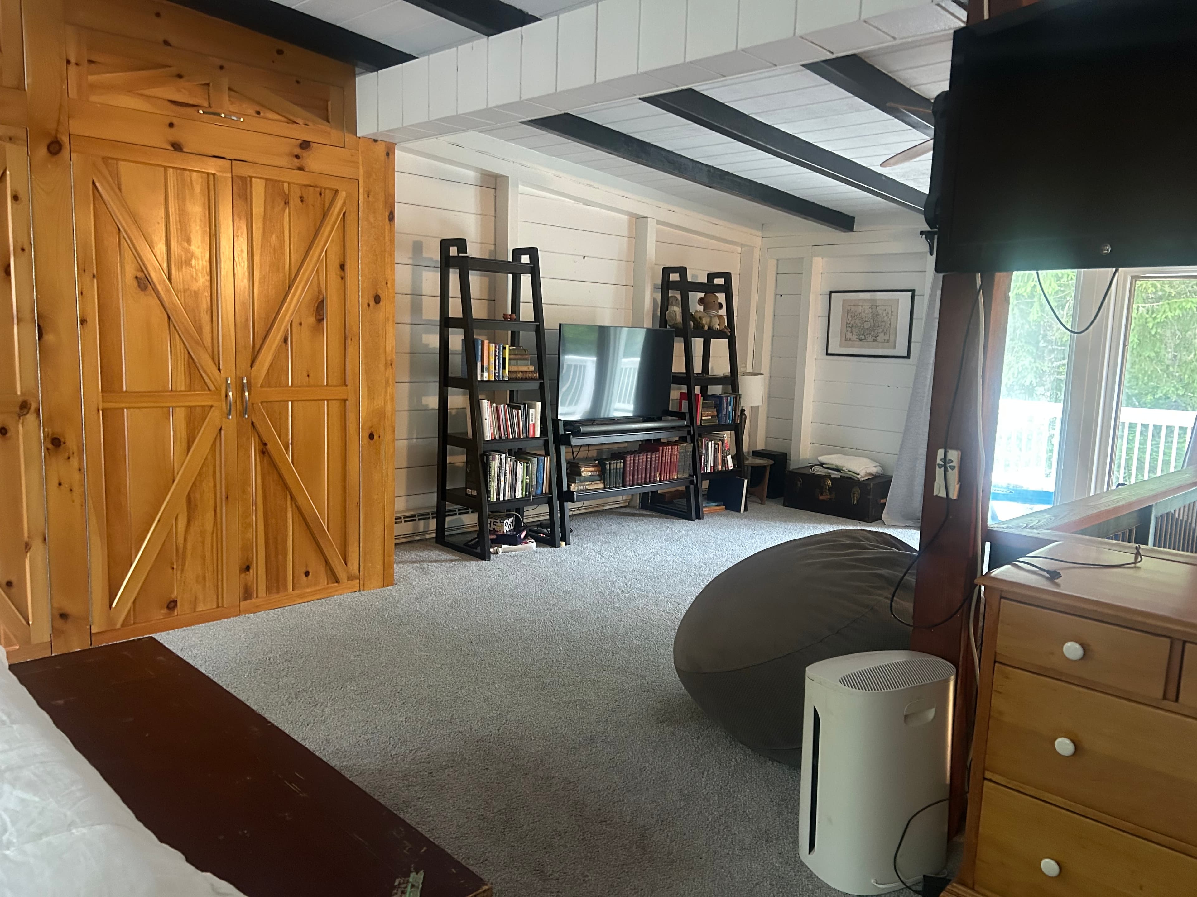 Loft sitting area — bookshelves, beanbag, painted stripe floor