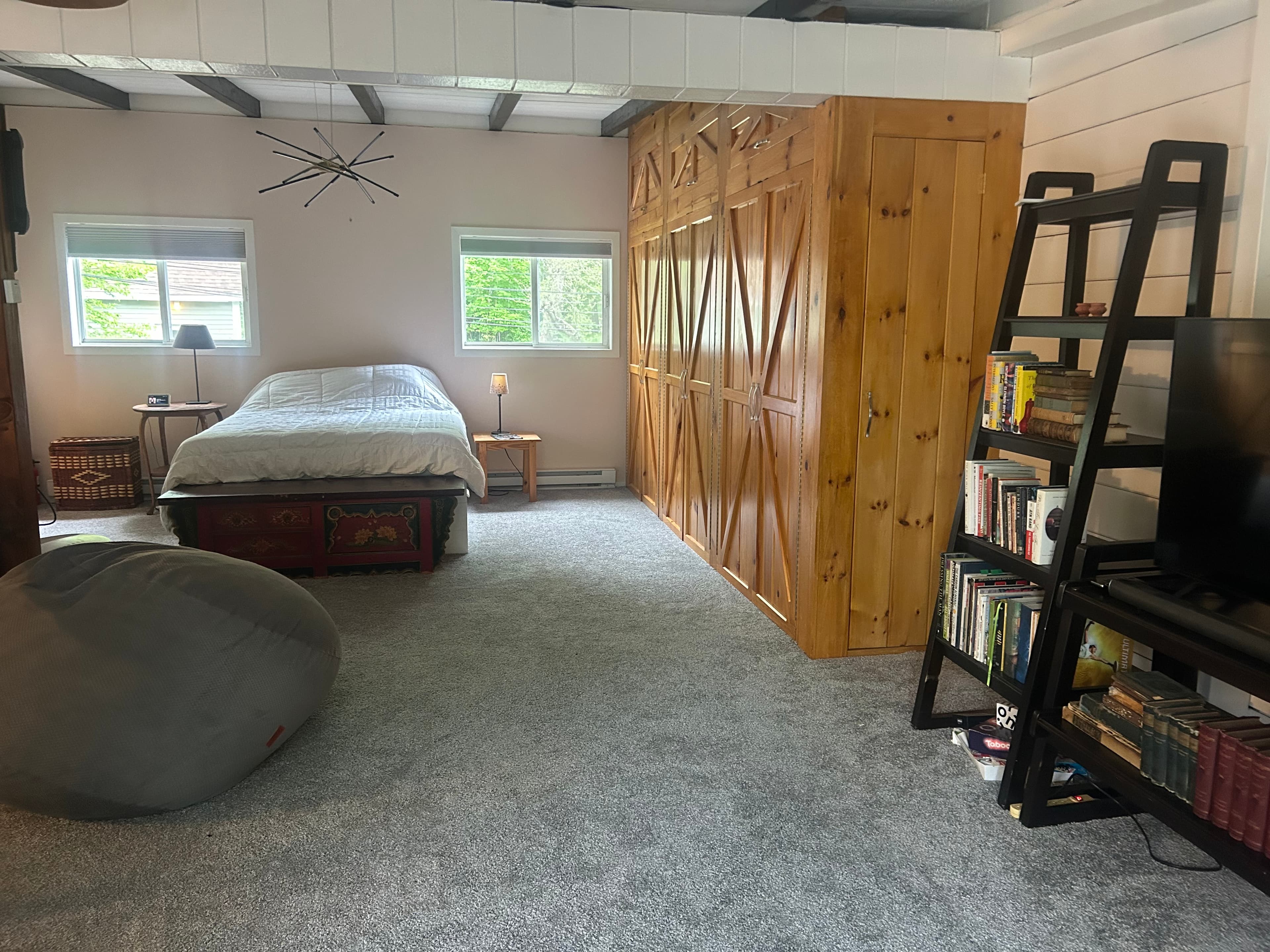 Primary bedroom with bookshelf and barn-door closet